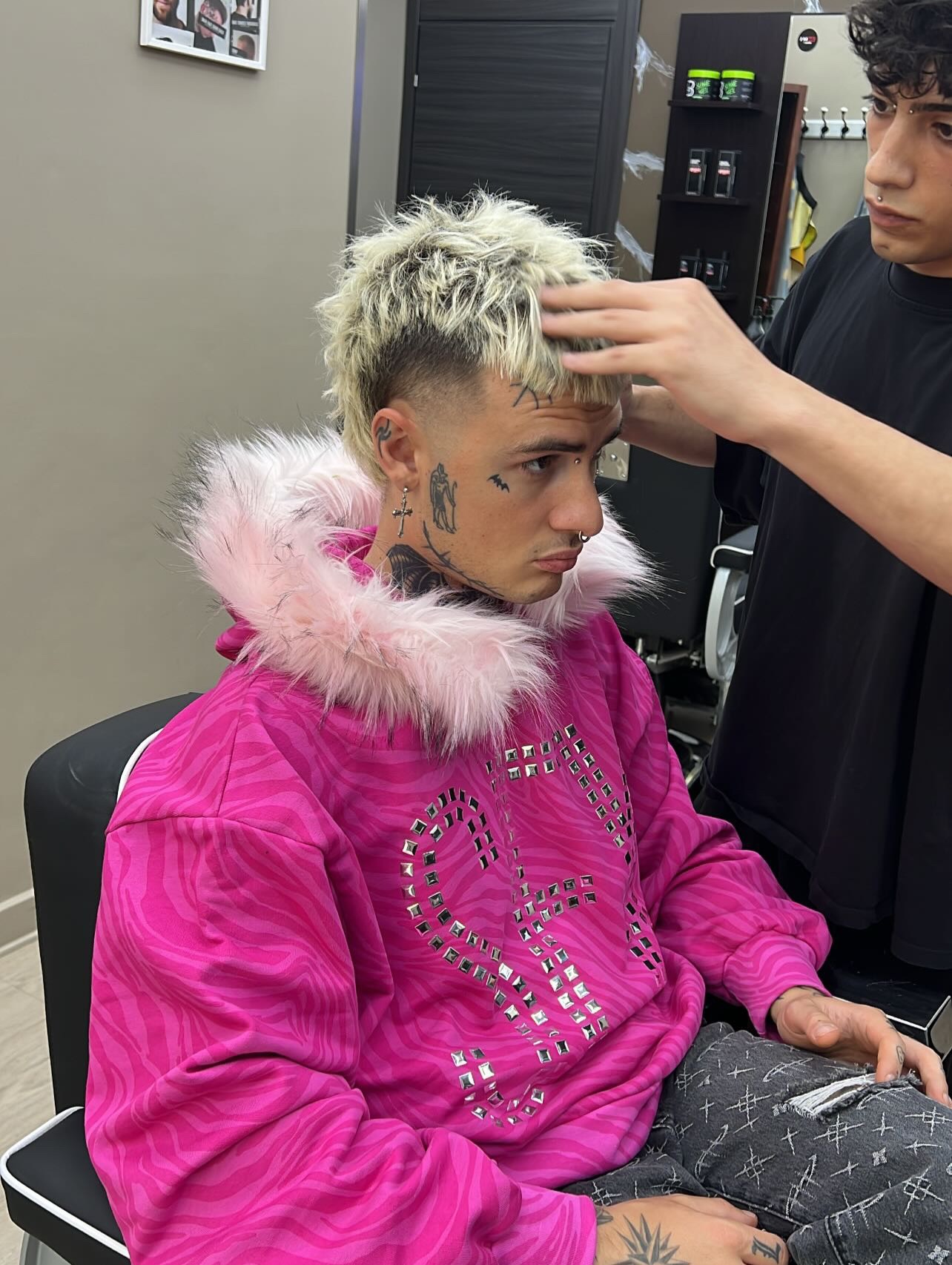 Cliente con taglio biondo platino texturizzato durante lo styling